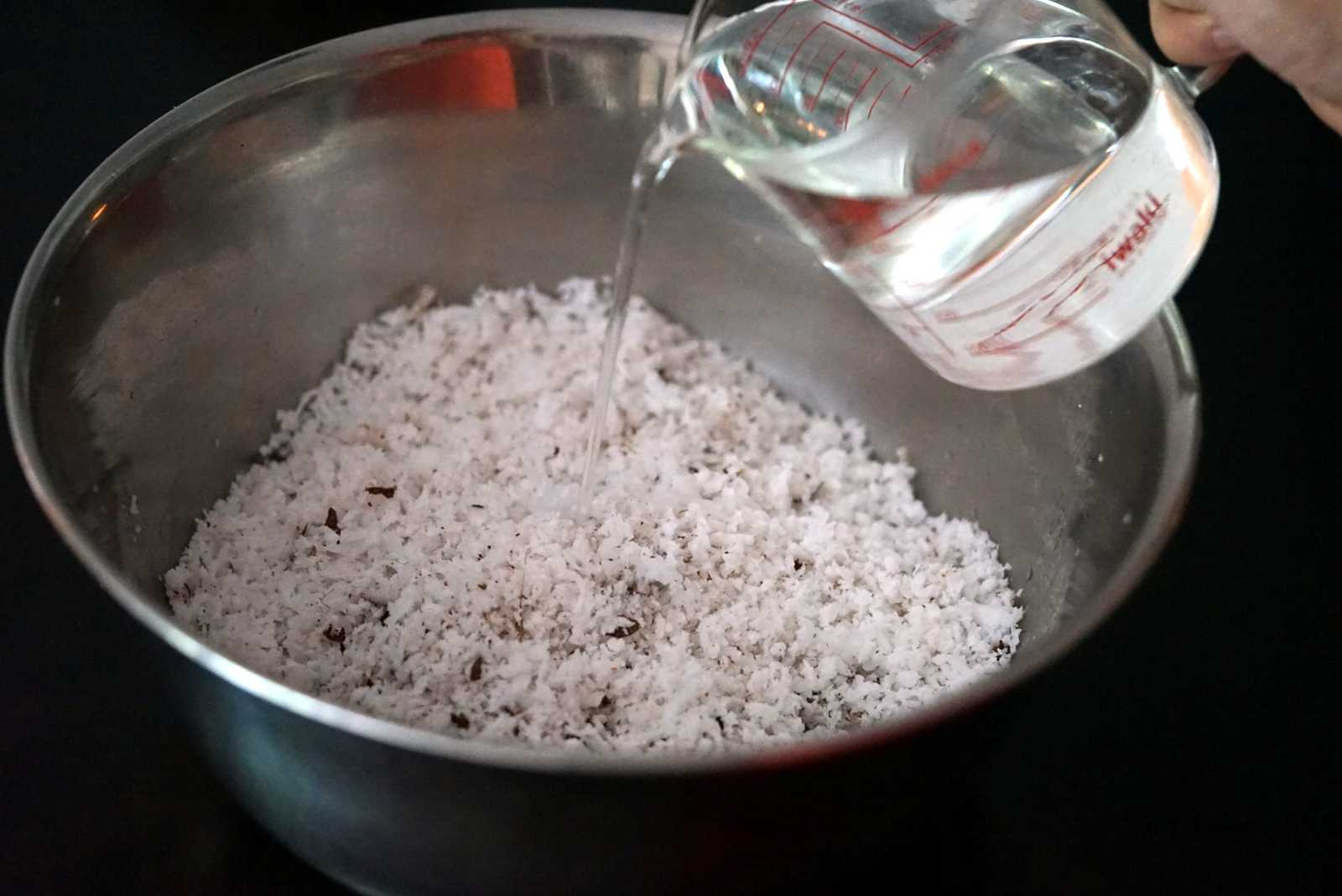 Adding water to the coconut meat